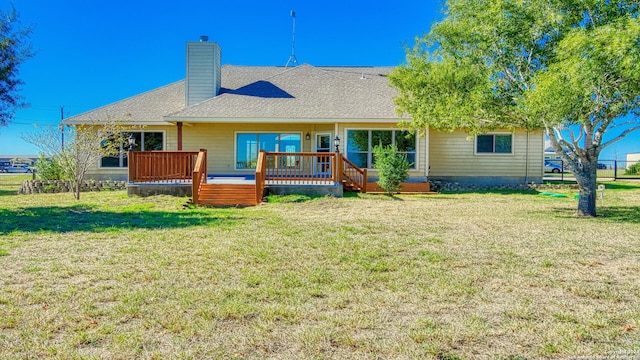 rear view of property with a lawn