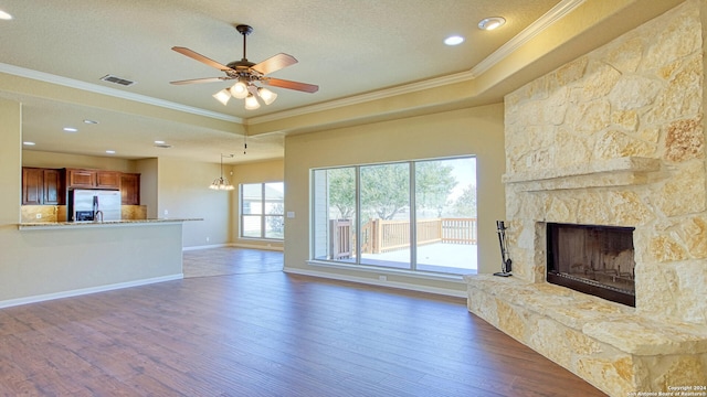 unfurnished living room with dark hardwood / wood-style floors, crown molding, and a fireplace