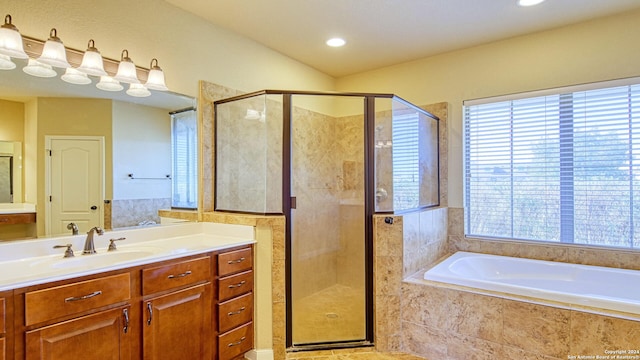 bathroom featuring shower with separate bathtub and vanity