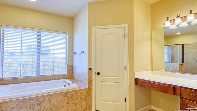 bathroom with separate shower and tub and vanity