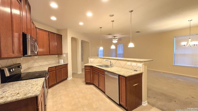 9019 Mimosa Mnr, San Antonio, TX 78245 - kitchen with stainless steel appliances, arched walkways, backsplash, a ceiling fan, and decorative light fixtures