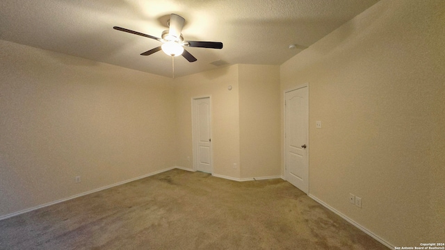 carpeted empty room featuring ceiling fan