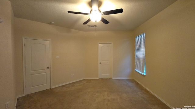 9019 Mimosa Mnr, San Antonio, TX 78245 - empty room featuring carpet floors, ceiling fan, a textured ceiling, and healthy amount of natural light