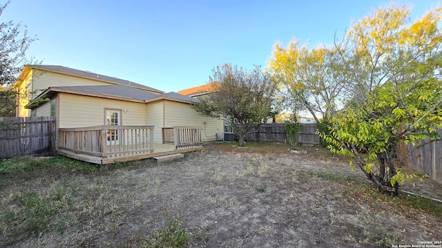 back of property with a deck and central air condition unit