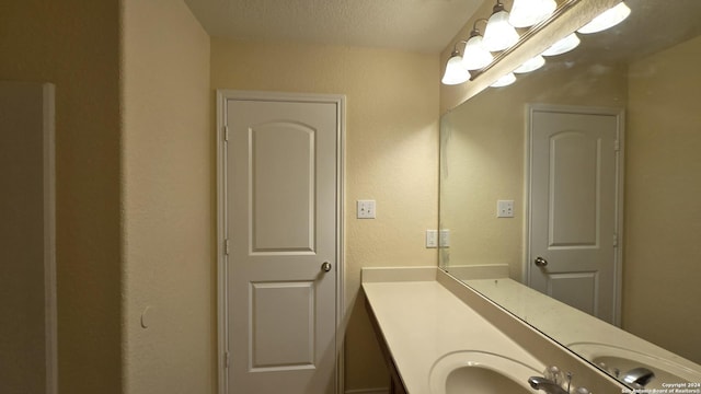 bathroom featuring vanity and a textured ceiling