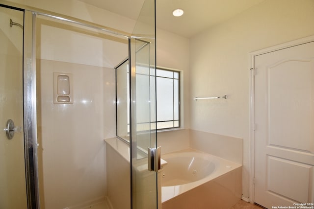 bathroom featuring shower with separate bathtub