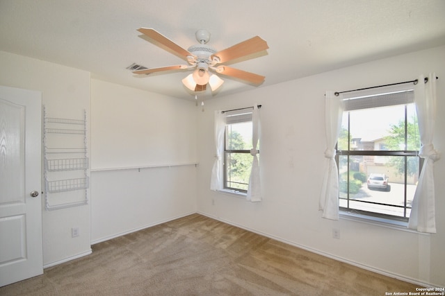 carpeted empty room with ceiling fan