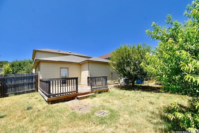 back of house featuring a yard and a wooden deck