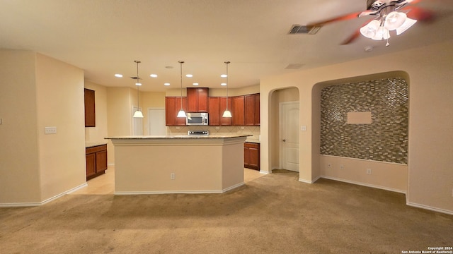 kitchen with pendant lighting, a center island, light colored carpet, and tasteful backsplash