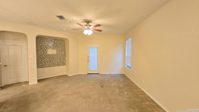 9019 Mimosa Mnr, San Antonio, TX 78245 - carpeted empty room with ceiling fan and arched walkways