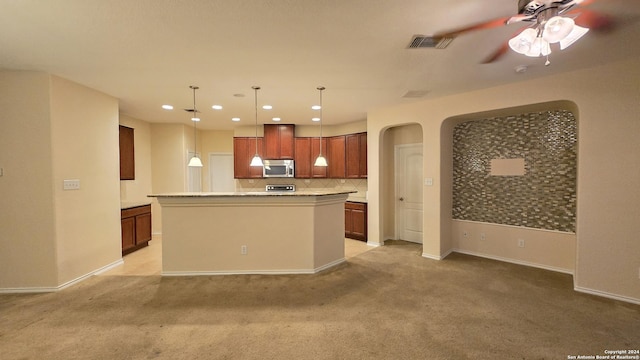 9019 Mimosa Mnr, San Antonio, TX 78245 - kitchen with stainless steel microwave, light colored carpet, ceiling fan, arched walkways, and tasteful backsplash