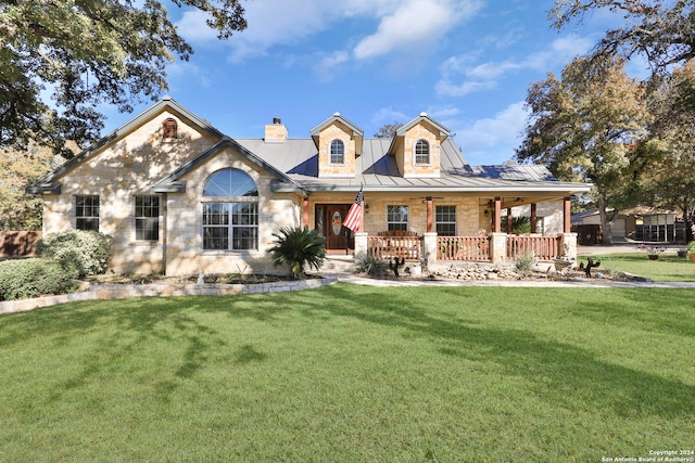 view of front of home with a porch and a front lawn