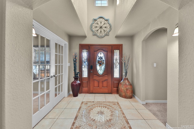 tiled foyer featuring french doors