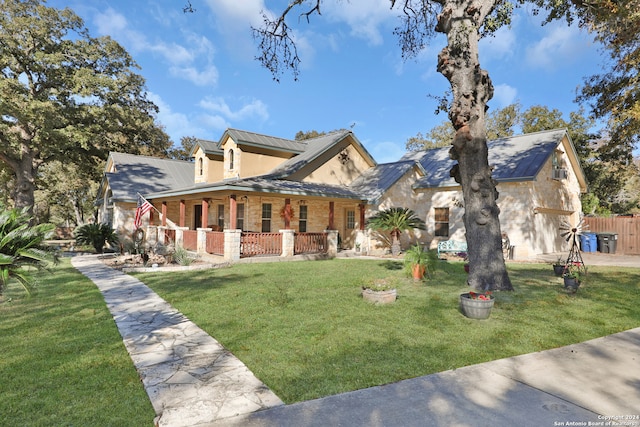 view of front of house with covered porch and a front yard