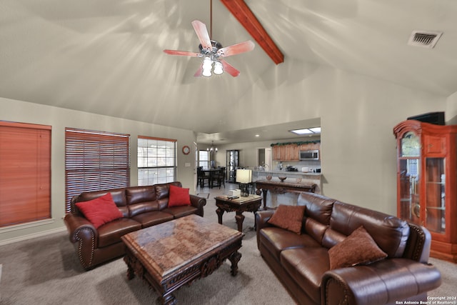 carpeted living room with ceiling fan, beamed ceiling, and high vaulted ceiling