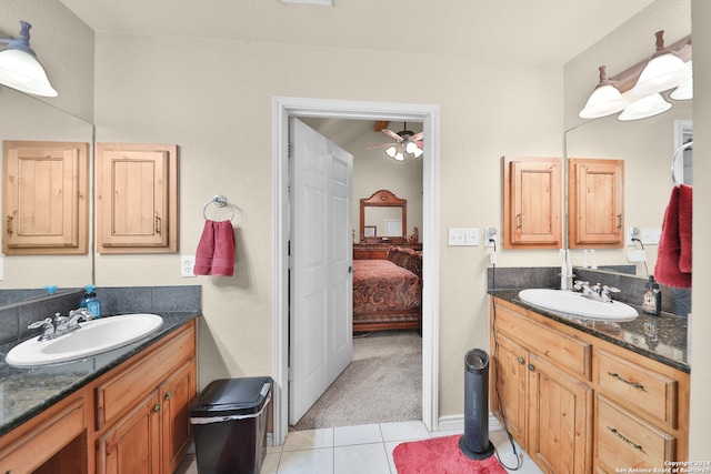 bathroom with tile patterned flooring, vanity, and ceiling fan