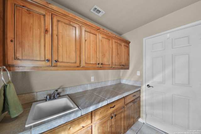 kitchen featuring light tile patterned flooring and sink