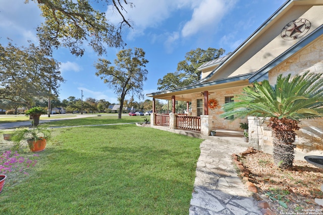 view of yard with covered porch