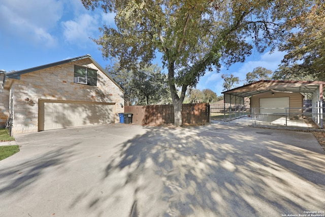 view of property exterior with a carport and an outbuilding