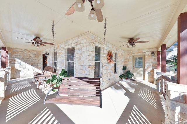 view of patio with ceiling fan and a porch