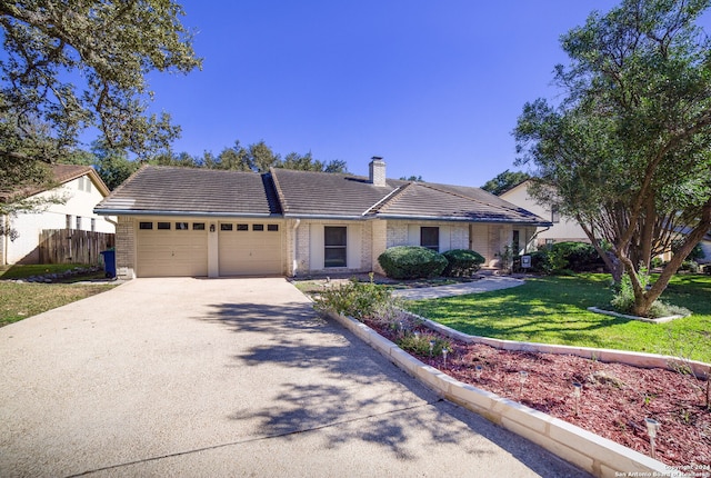 ranch-style home featuring a front yard and a garage