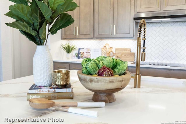 room details with decorative backsplash and light brown cabinetry