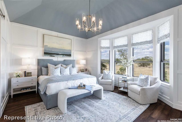 bedroom with dark wood-type flooring, a notable chandelier, and vaulted ceiling