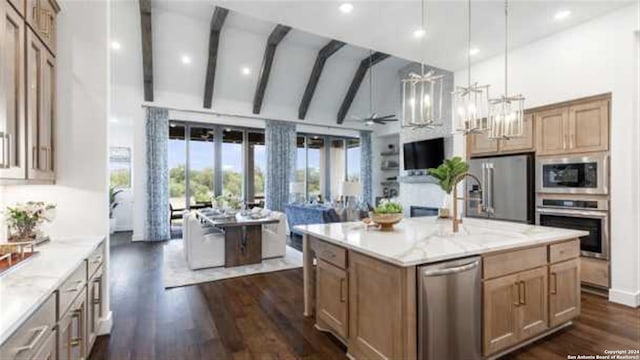 kitchen featuring appliances with stainless steel finishes, decorative light fixtures, dark wood-type flooring, high vaulted ceiling, and an island with sink