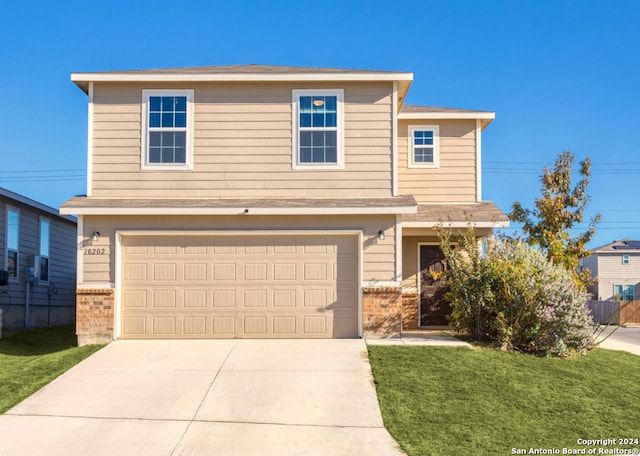 view of property with a front yard and a garage