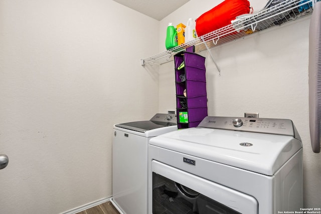 washroom with wood-type flooring and washing machine and clothes dryer