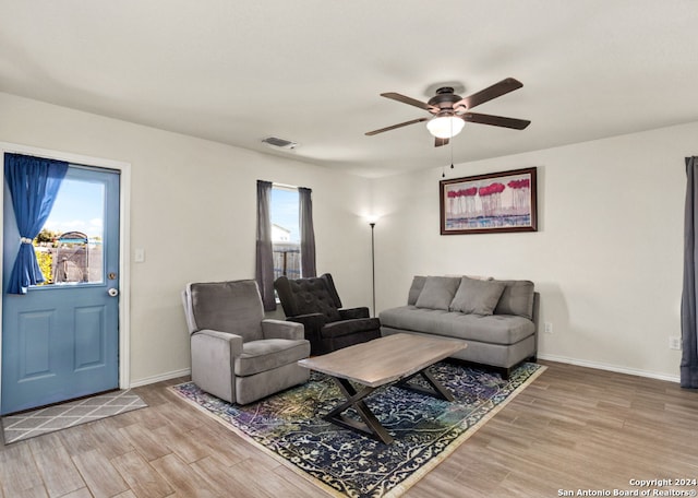 living room with hardwood / wood-style floors and ceiling fan