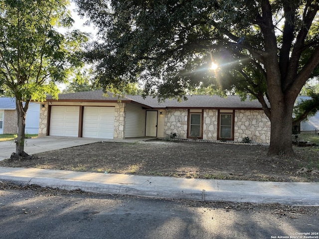 811 Thrasher Dr, San Antonio, TX 78245 - view of front of house featuring stone siding, an attached garage, concrete driveway, and a shingled roof