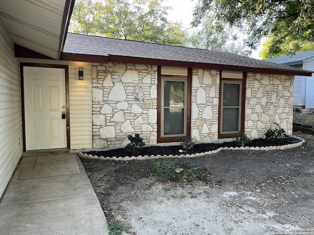 811 Thrasher Dr, San Antonio, TX 78245 - entrance to property featuring stone siding and roof with shingles
