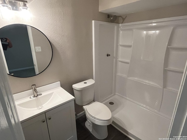 811 Thrasher Dr, San Antonio, TX 78245 - bathroom featuring vanity, a textured wall, a shower, and toilet