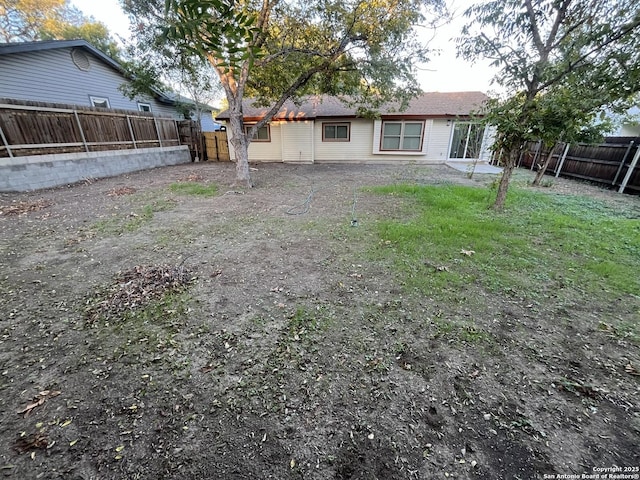 back of house with a lawn