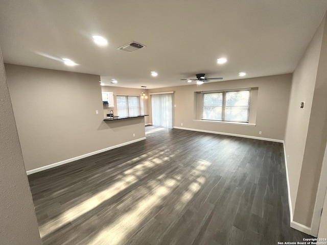 811 Thrasher Dr, San Antonio, TX 78245 - unfurnished living room featuring baseboards, recessed lighting, a ceiling fan, and dark wood-style flooring