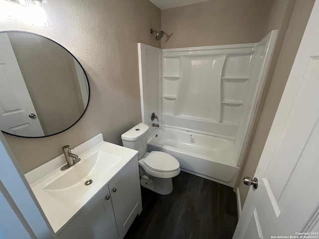 full bathroom featuring hardwood / wood-style floors, vanity, toilet, and shower / washtub combination