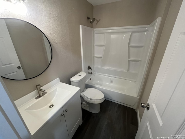 811 Thrasher Dr, San Antonio, TX 78245 - full bathroom featuring vanity, wood finished floors, toilet, shower / washtub combination, and a textured wall