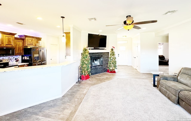 living room with ceiling fan, ornamental molding, and light hardwood / wood-style flooring