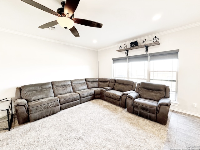 living room featuring ceiling fan, light colored carpet, and ornamental molding