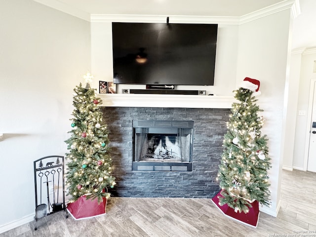 interior details with hardwood / wood-style floors, a fireplace, and crown molding