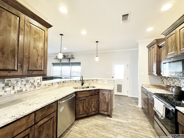 kitchen with stainless steel appliances, plenty of natural light, hanging light fixtures, and sink