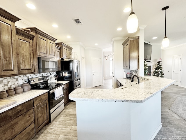 kitchen with backsplash, hanging light fixtures, ornamental molding, appliances with stainless steel finishes, and kitchen peninsula