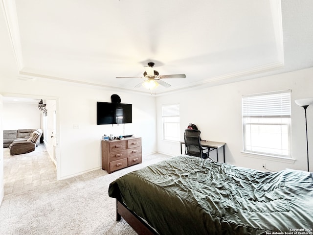 bedroom featuring multiple windows, ceiling fan, crown molding, and light carpet