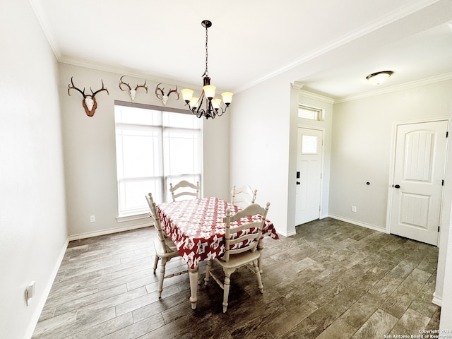 dining area with crown molding, dark wood-type flooring, and a notable chandelier