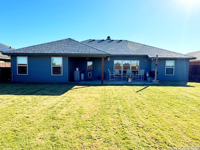 rear view of property with central air condition unit, a patio area, and a yard