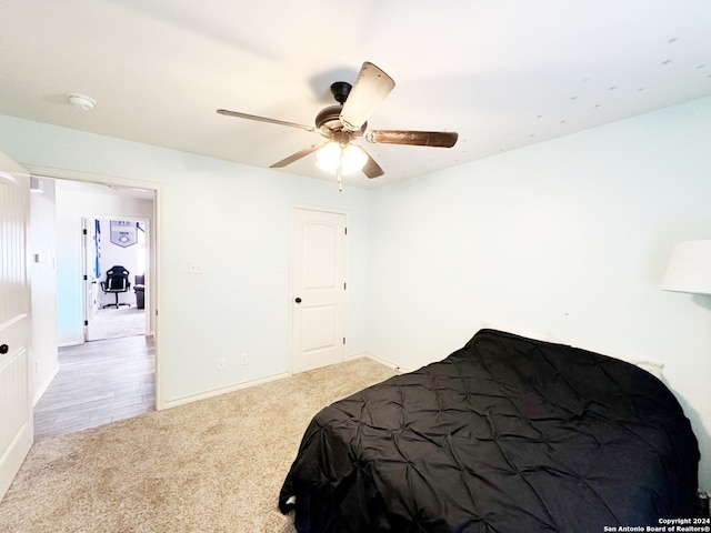 bedroom featuring ceiling fan and light carpet