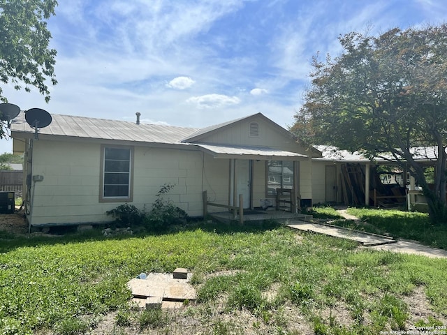 1714 Constantinople St, Castroville, TX 78009 - view of front facade featuring central AC unit, a front lawn, and metal roof