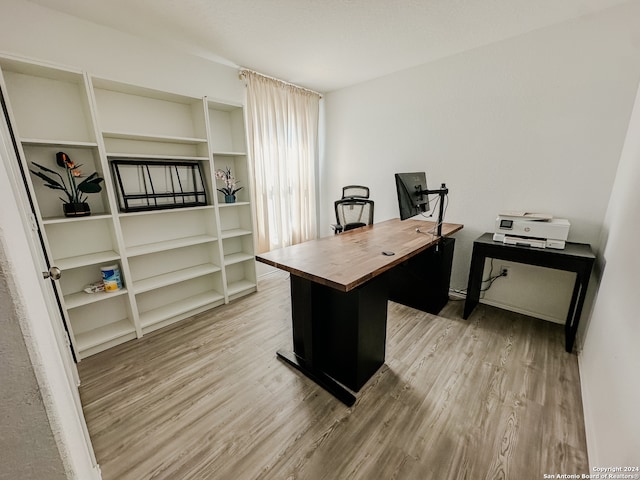 office with light wood-type flooring