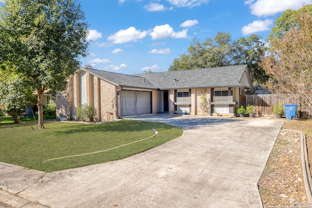 ranch-style house featuring a front yard and a garage